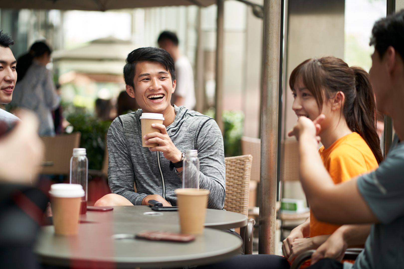 Young,Asian,Adults,Men,And,Woman,Sitting,Chatting,Relaxing,In