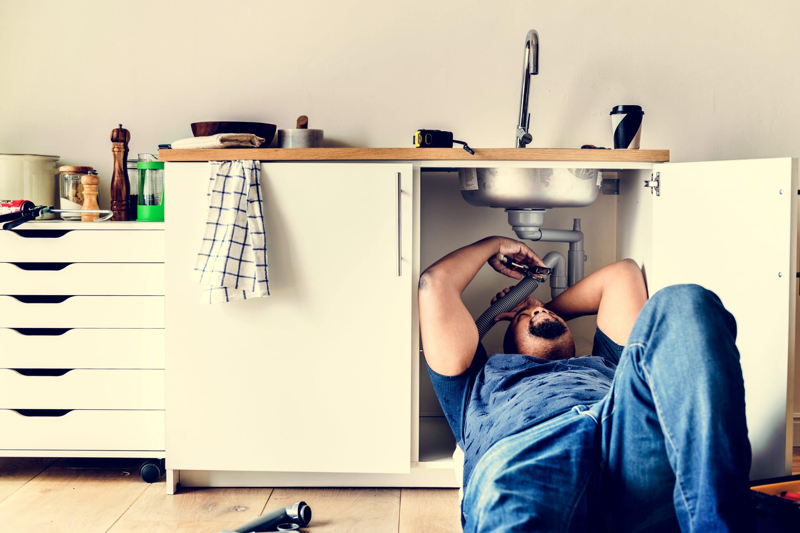 plumber fixing a condo that he is maintaining