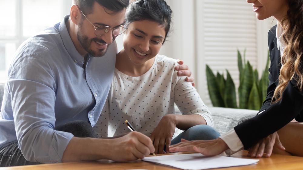 couple signing condominium turnover documents