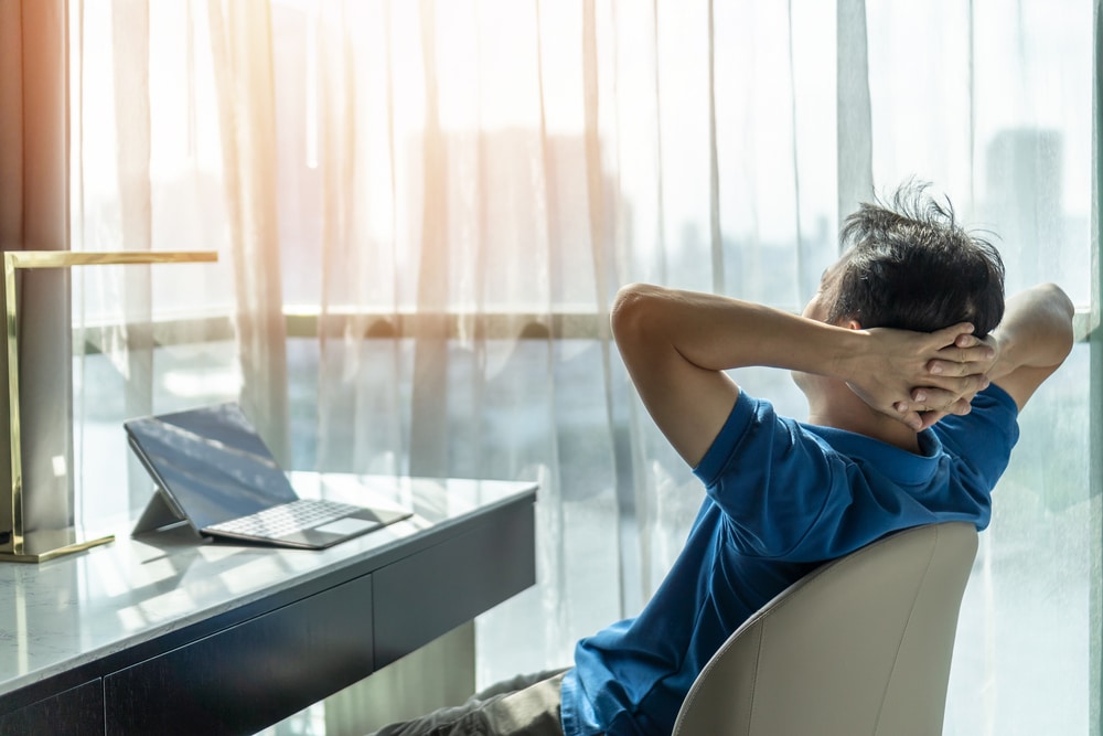 man relaxing after working in home office