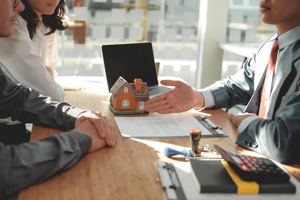 couple talking to an agent of a real estate developer