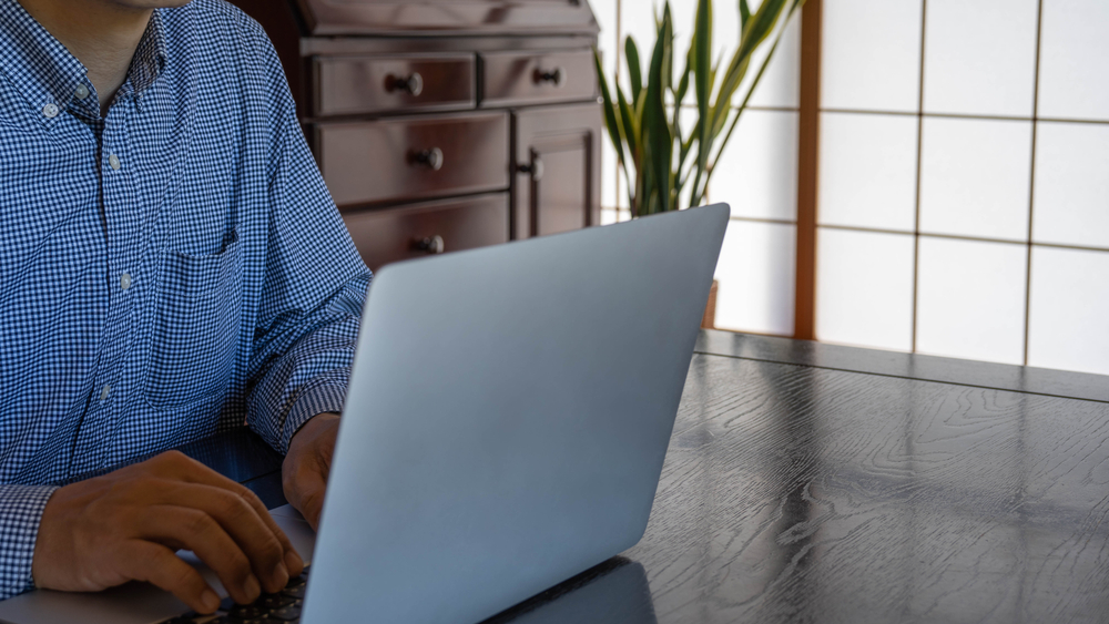 businessman working in home office separated by a shoji screen