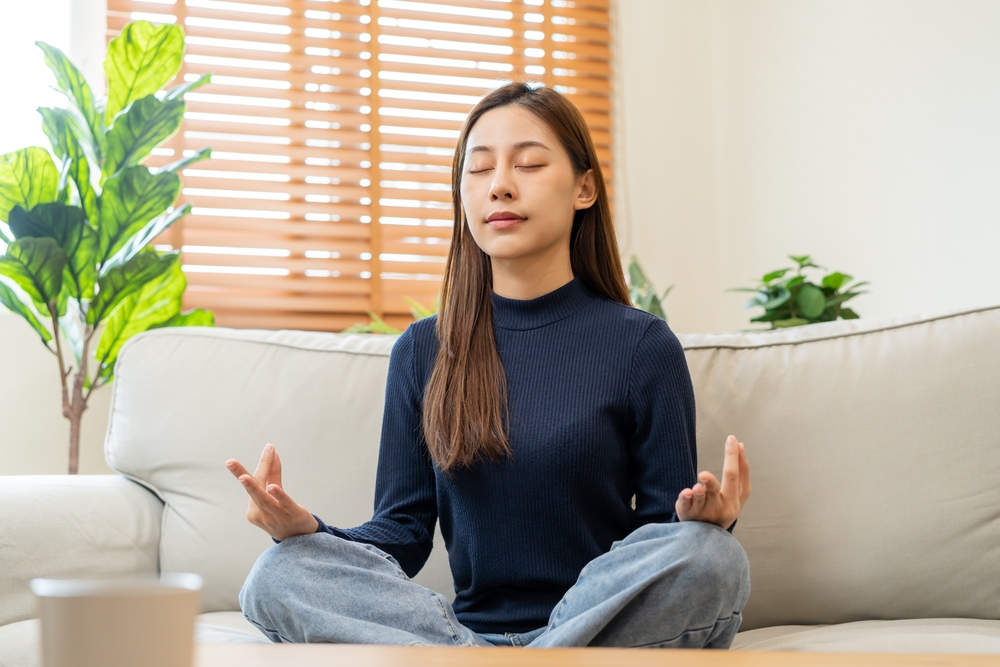 Woman meditating as part of her self care activities