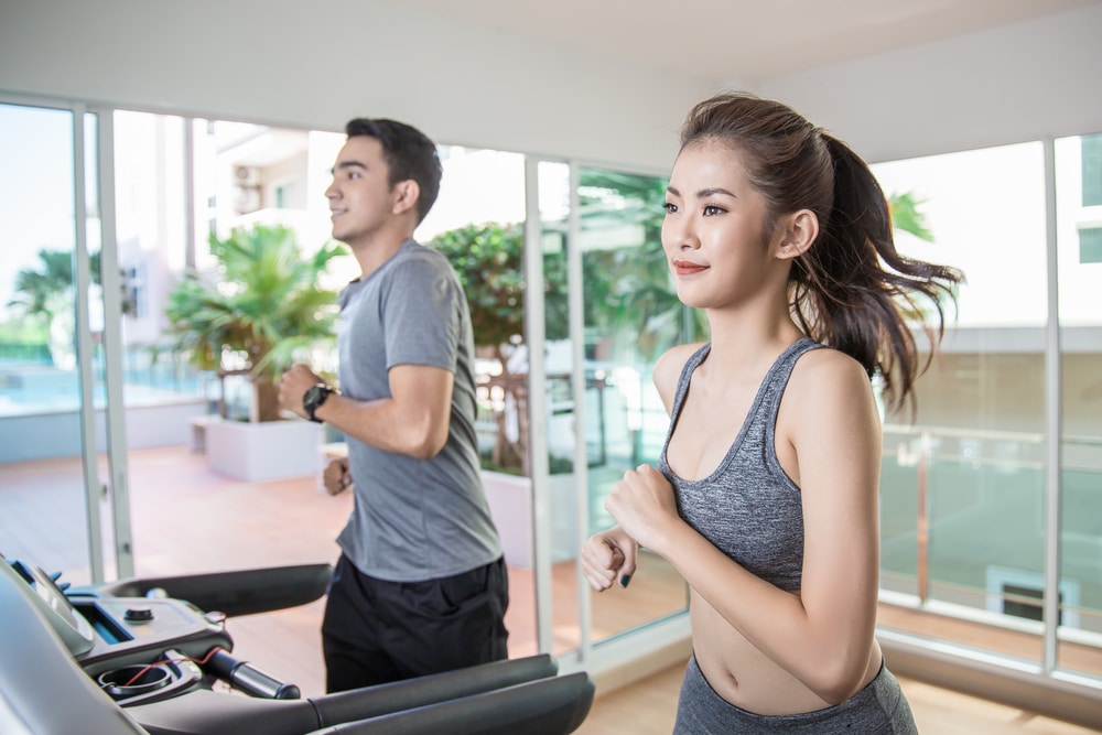 man and woman working out in a condo gym