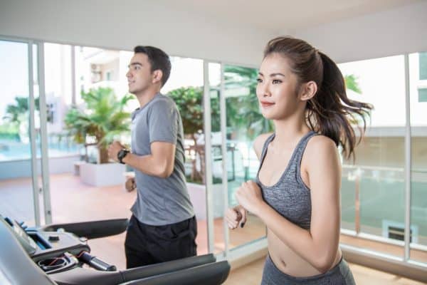 a photo two people working out on a treadmill.