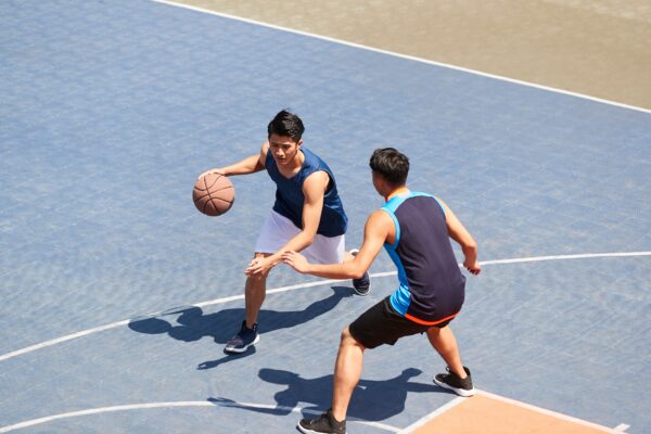 two men playing basketball in their condo