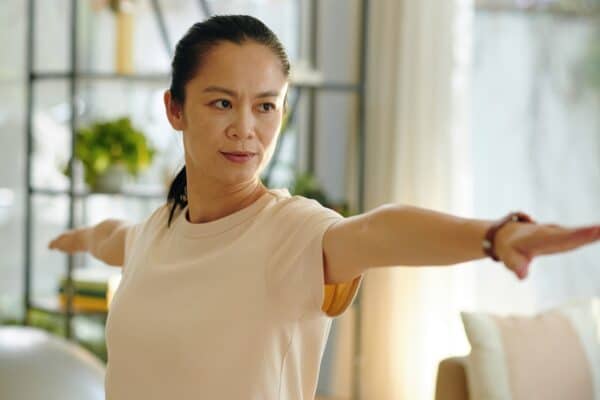 woman practicing tai chi inside condo banner