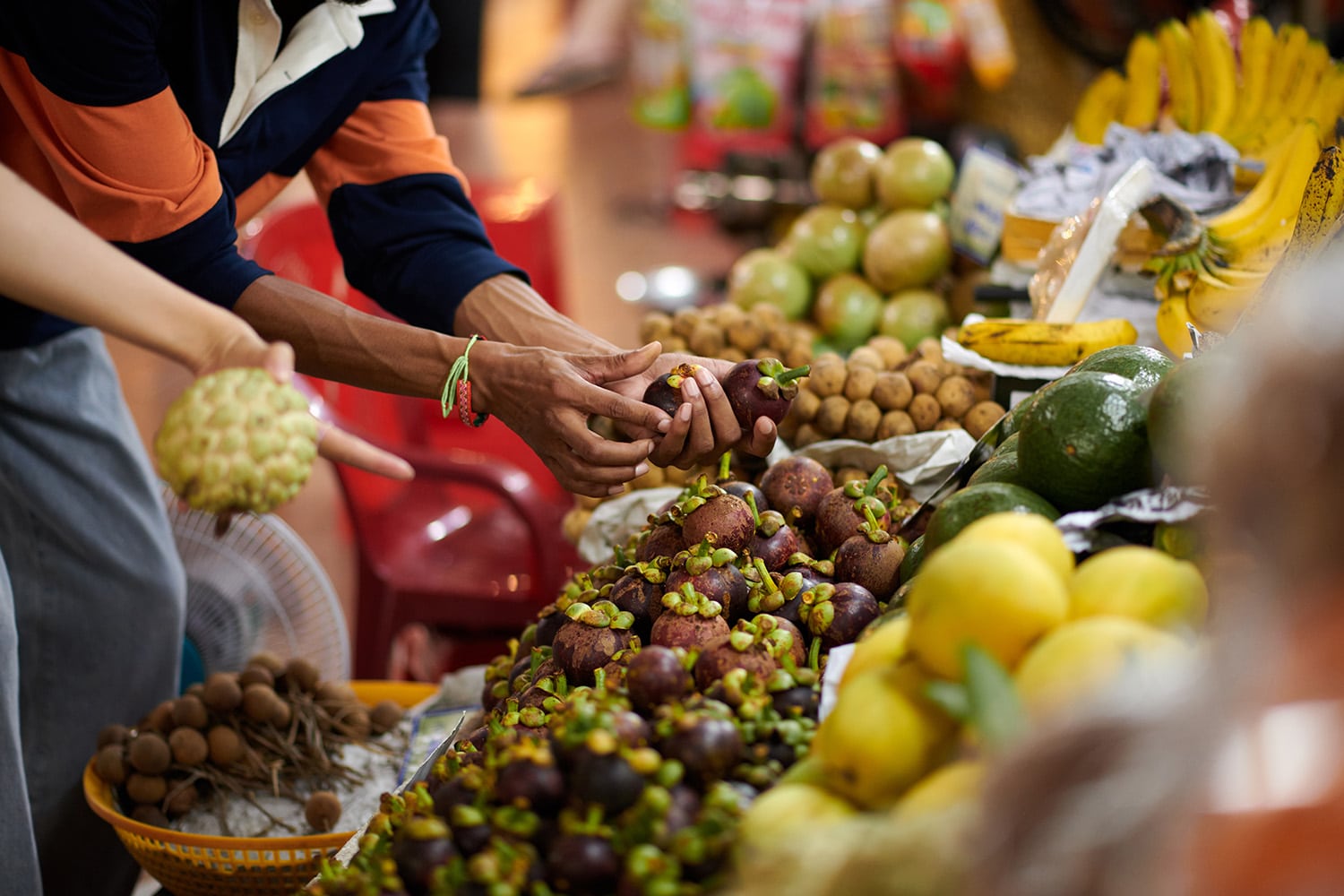 people buying fruits in market
