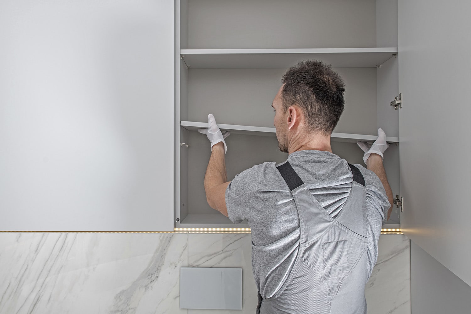 man fixing cabinet