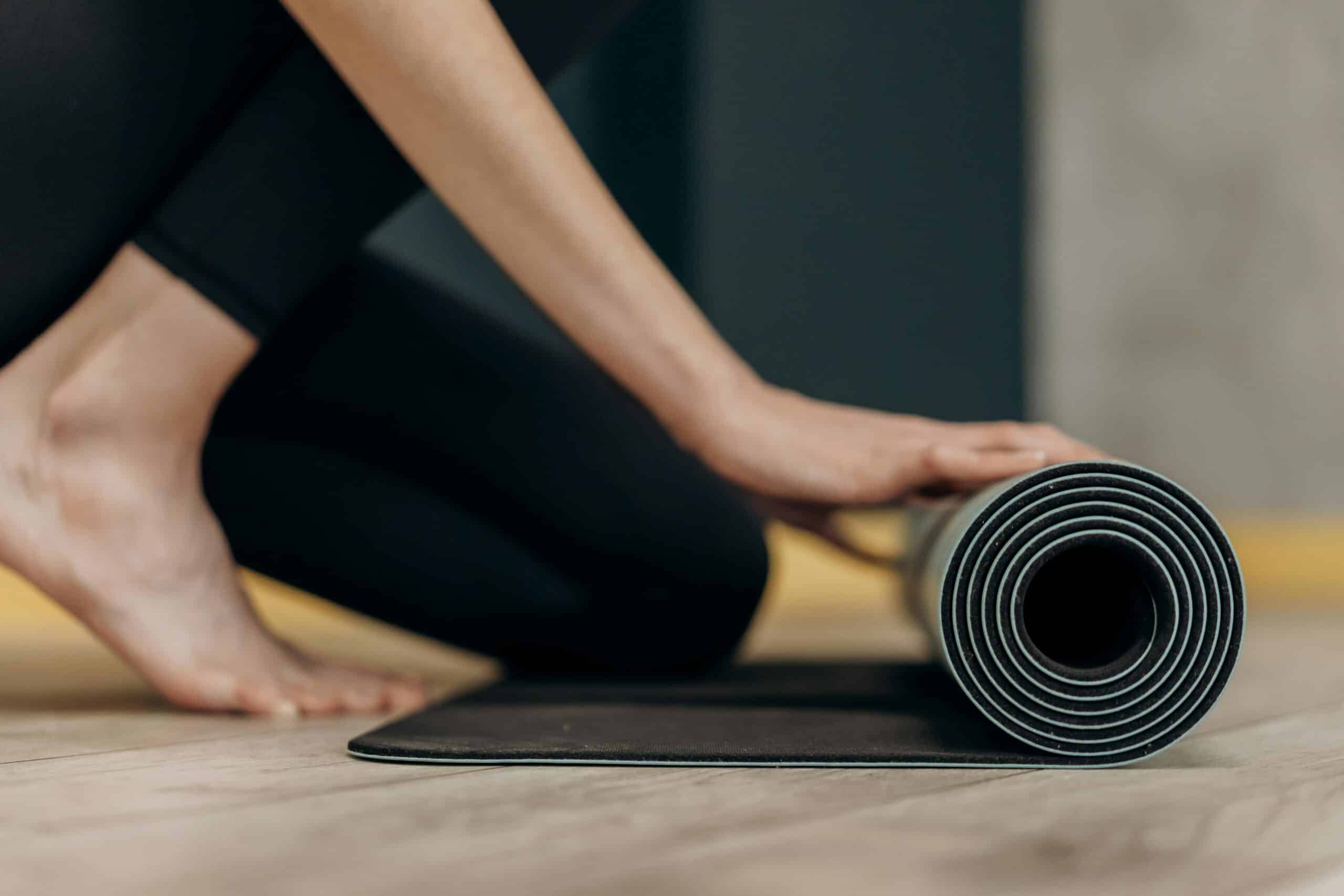 woman unrolling yoga mat